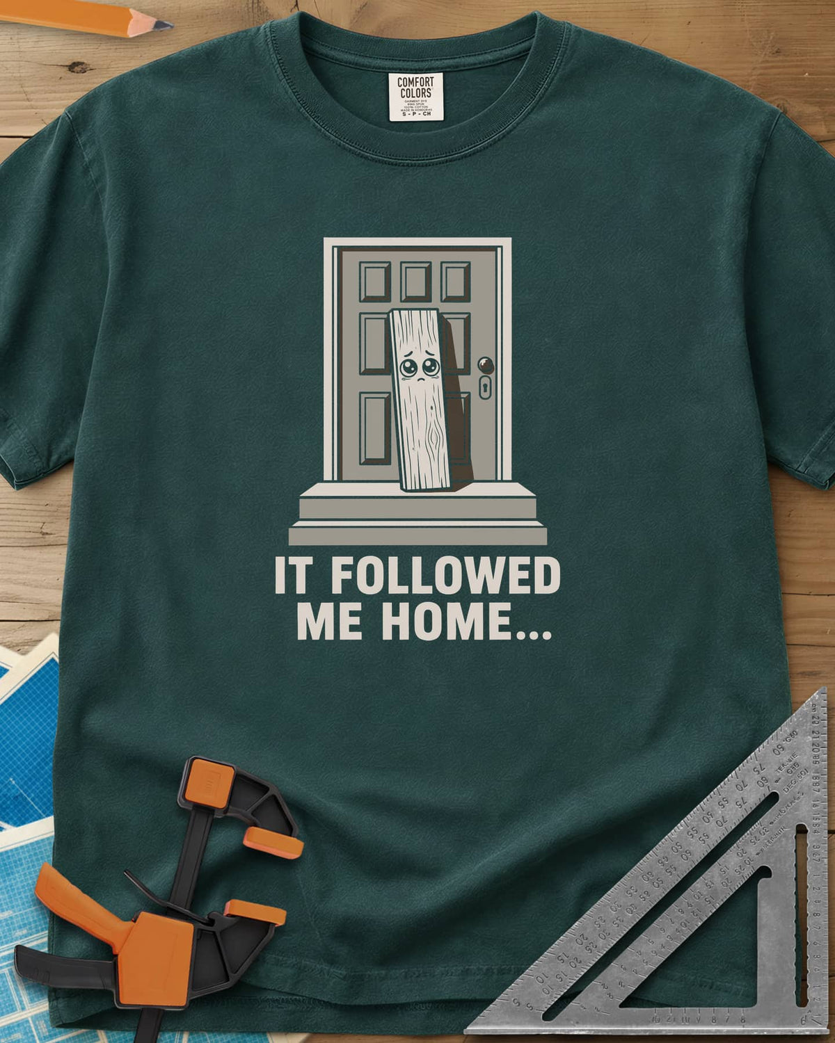 It Followed Me Home Woodworking heavyweight tee in Blue Spruce, sad-eyed plank of wood waiting on a doorstep