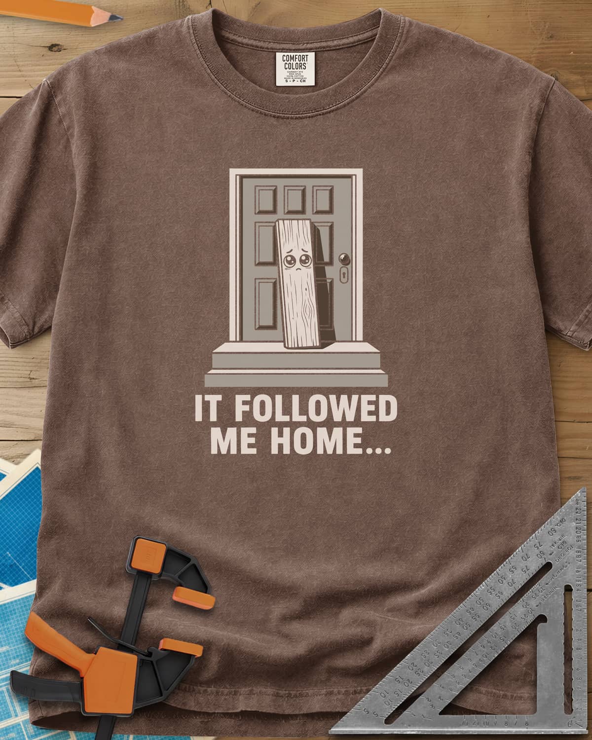 It Followed Me Home Woodworking heavyweight tee in Espresso, sad-eyed plank of wood waiting on a doorstep