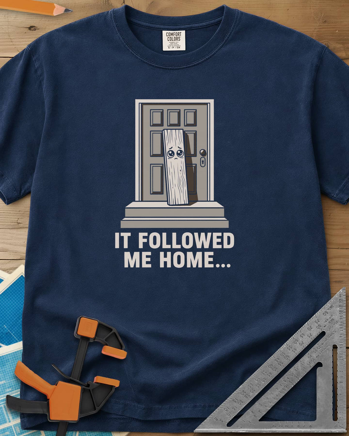 It Followed Me Home Woodworking heavyweight tee in Navy, sad-eyed plank of wood waiting on a doorstep