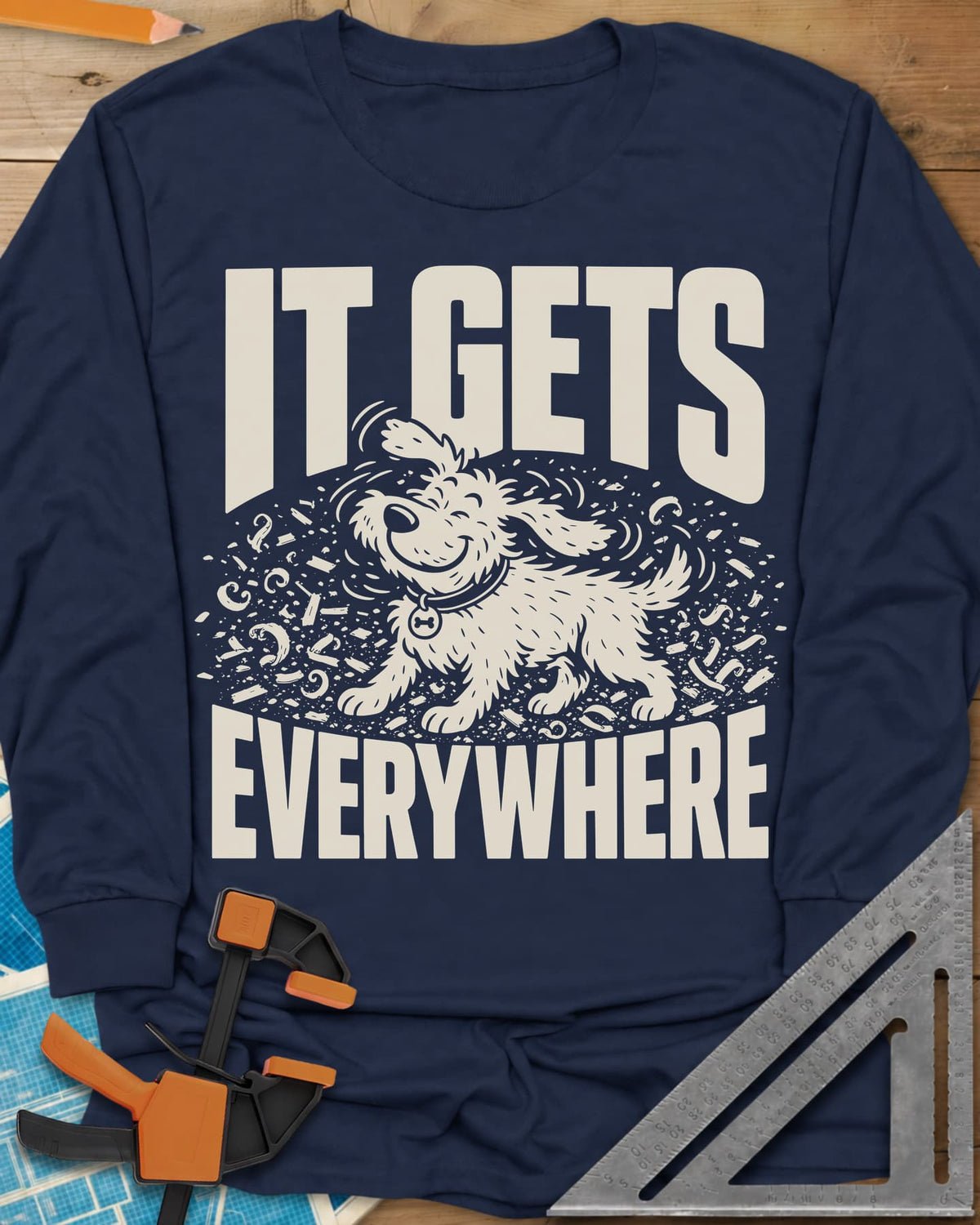 It Gets Everywhere long sleeve shirt in Navy, a happy shaggy dog shaking in a swirl of wood shavings