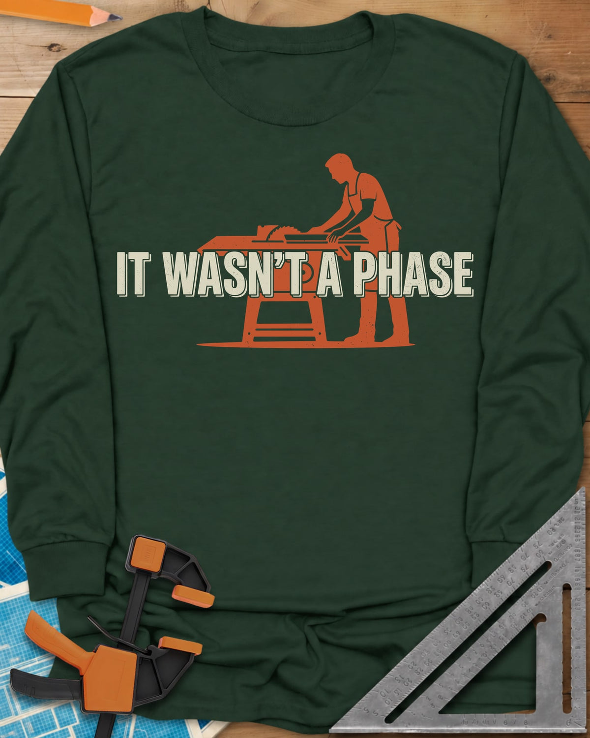 It Was Not A Phase Woodworking long sleeve shirt in Forest Green, a rust-orange silhouette of a woodworker in an apron at a