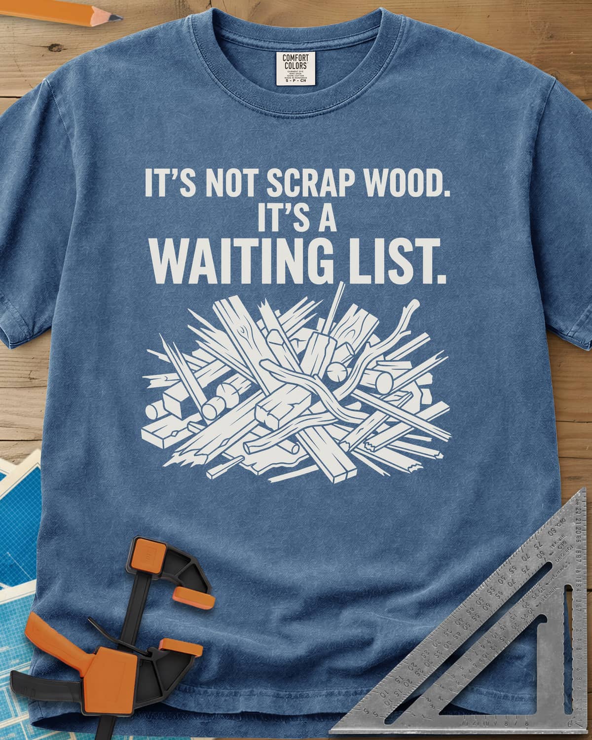 It's A Waiting List heavyweight tee in Blue Jean, a tangled heap of scrap boards, offcuts and branches
