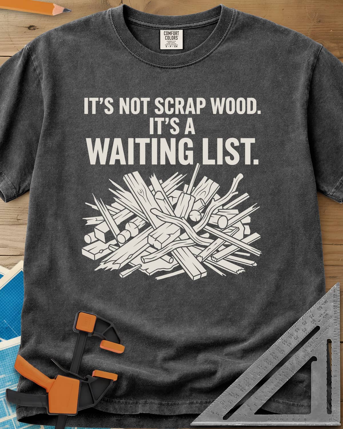 It's A Waiting List heavyweight tee in Pepper, a tangled heap of scrap boards, offcuts and branches