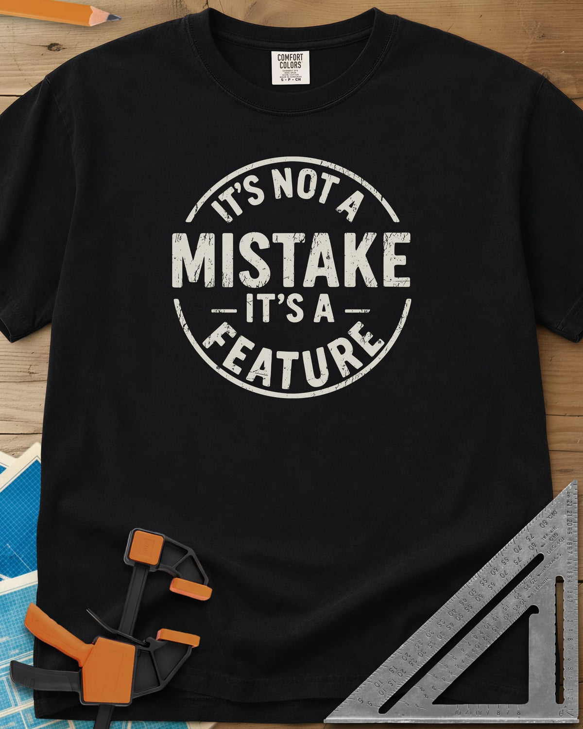 It's Not a Mistake heavyweight tee in Black, a worn circular stamp with MISTAKE in large letters at the center