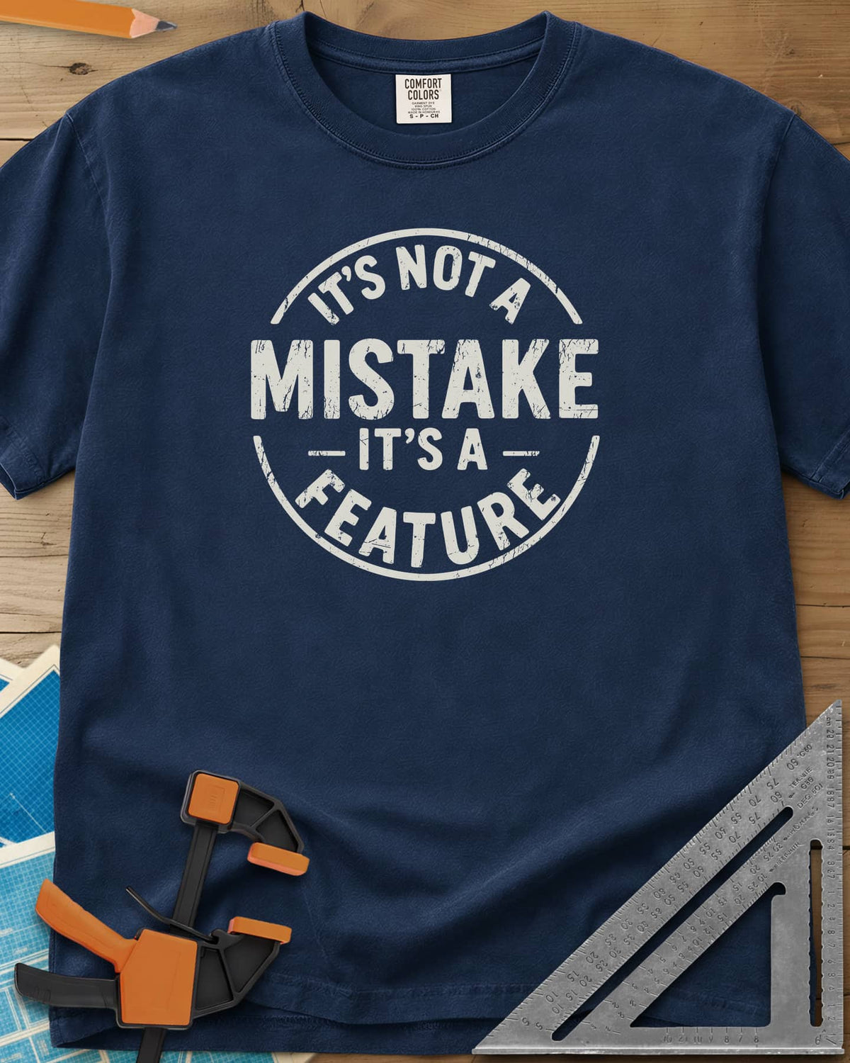 It's Not a Mistake heavyweight tee in Navy, a worn circular stamp with MISTAKE in large letters at the center