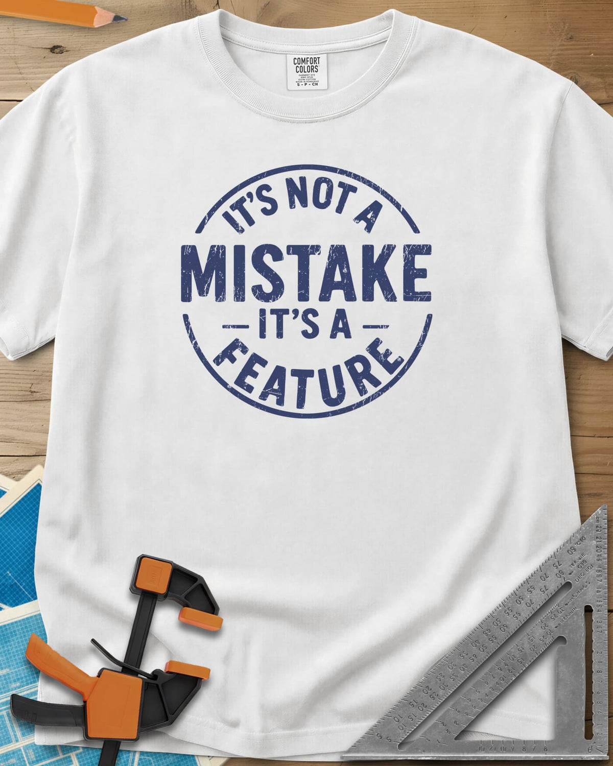 It's Not a Mistake heavyweight tee in White, a worn circular stamp with MISTAKE in large letters at the center
