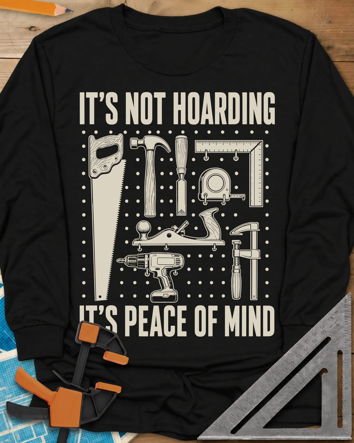 It's Not Hoarding It's Peace Of Mind long sleeve shirt in Black, a dotted pegboard grid of hand tools and a cordless drill