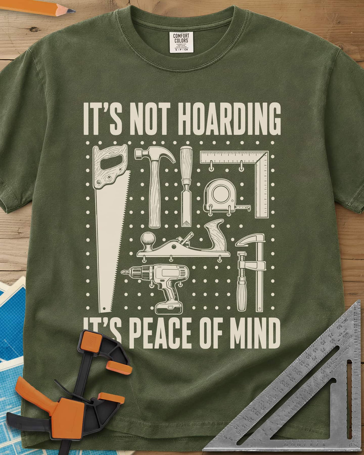 It's Not Hoarding It's Peace Of Mind heavyweight tee in Hemp, a dotted pegboard grid of hand tools and a cordless drill