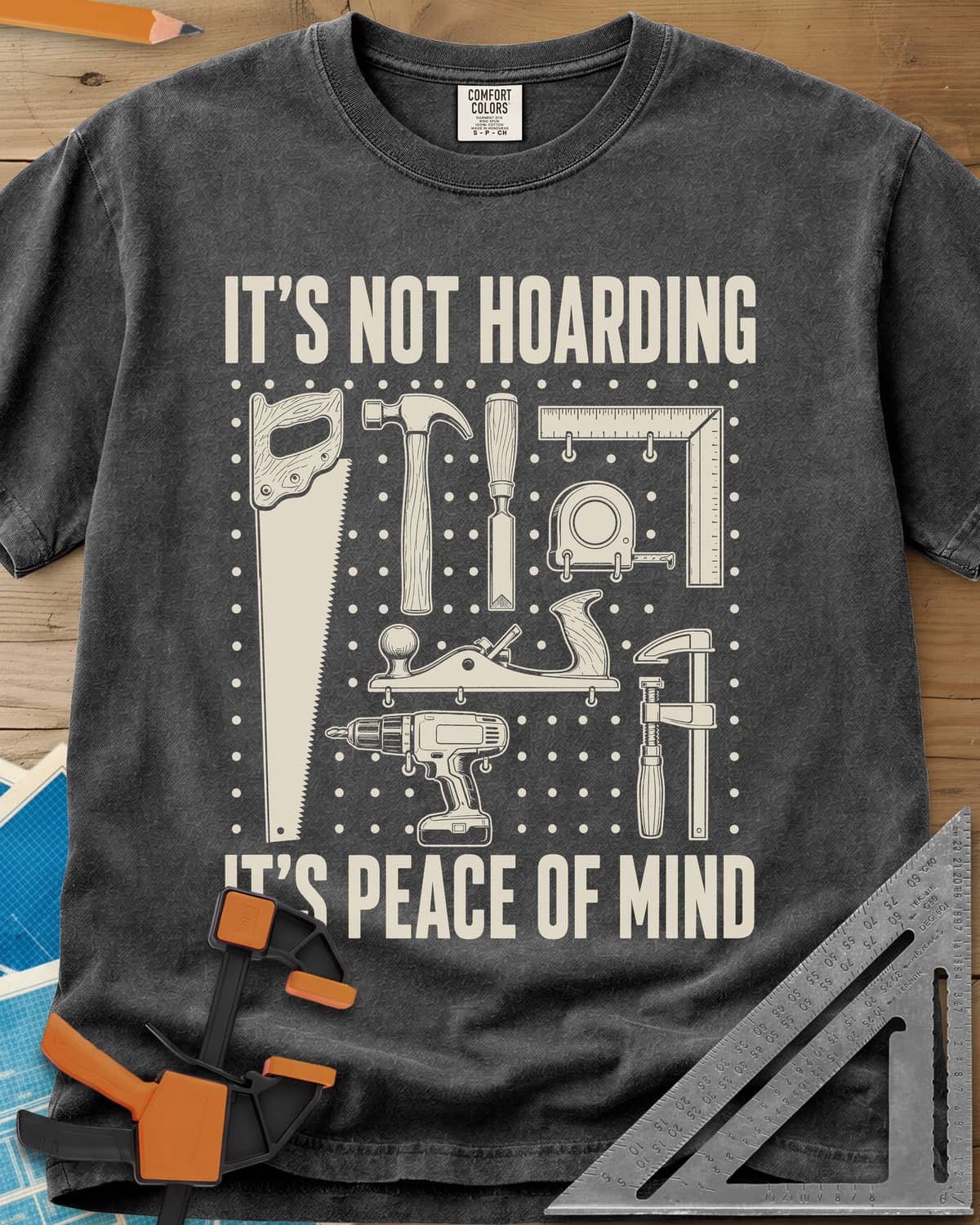 It's Not Hoarding It's Peace Of Mind heavyweight tee in Pepper, a dotted pegboard grid of hand tools and a cordless drill