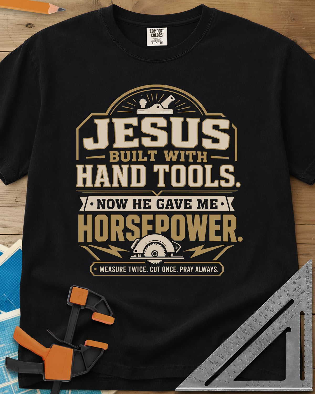 Jesus Built With Hand Tools heavyweight tee in Black, a hand plane over bold lettering, a circular saw with bolts below