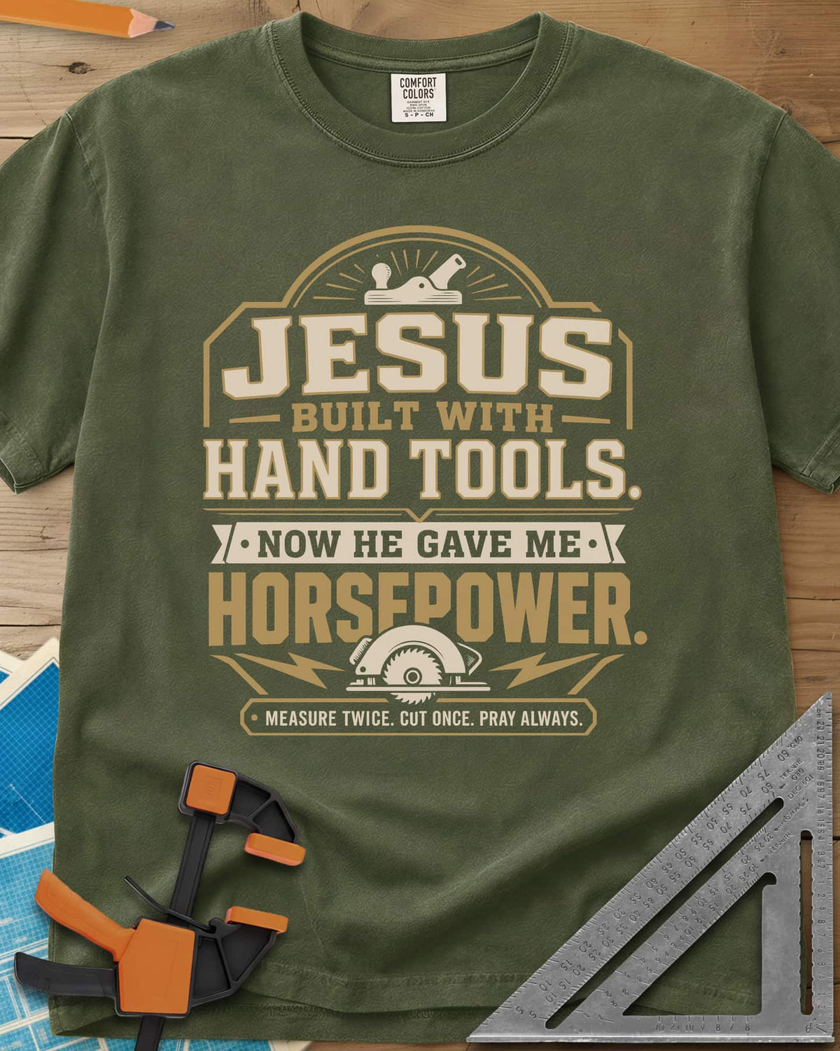 Jesus Built With Hand Tools heavyweight tee in Hemp, a hand plane over bold lettering, a circular saw with bolts below