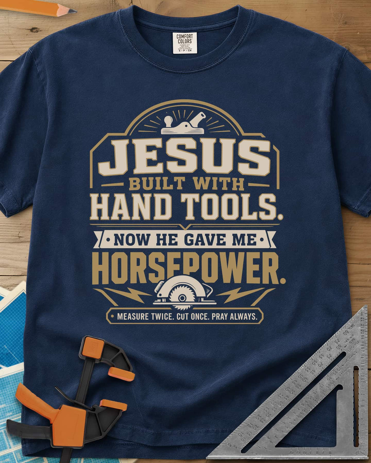 Jesus Built With Hand Tools heavyweight tee in Navy, a hand plane over bold lettering, a circular saw with bolts below