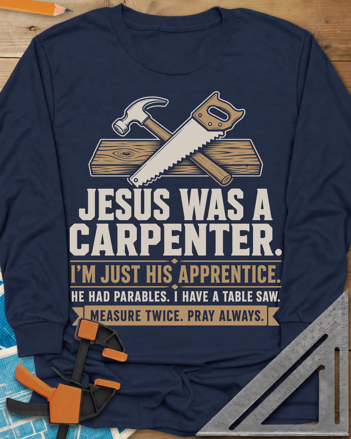 Jesus Was A Carpenter Apprentice long sleeve shirt in Navy, crossed hammer and hand saw over a plank, with stacked lettering
