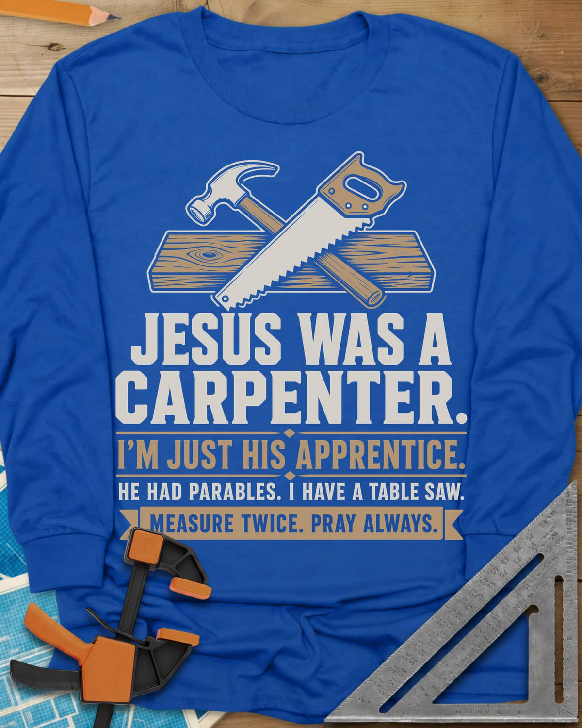 Jesus Was A Carpenter Apprentice long sleeve shirt in Royal, crossed hammer and hand saw over a plank, with stacked lettering