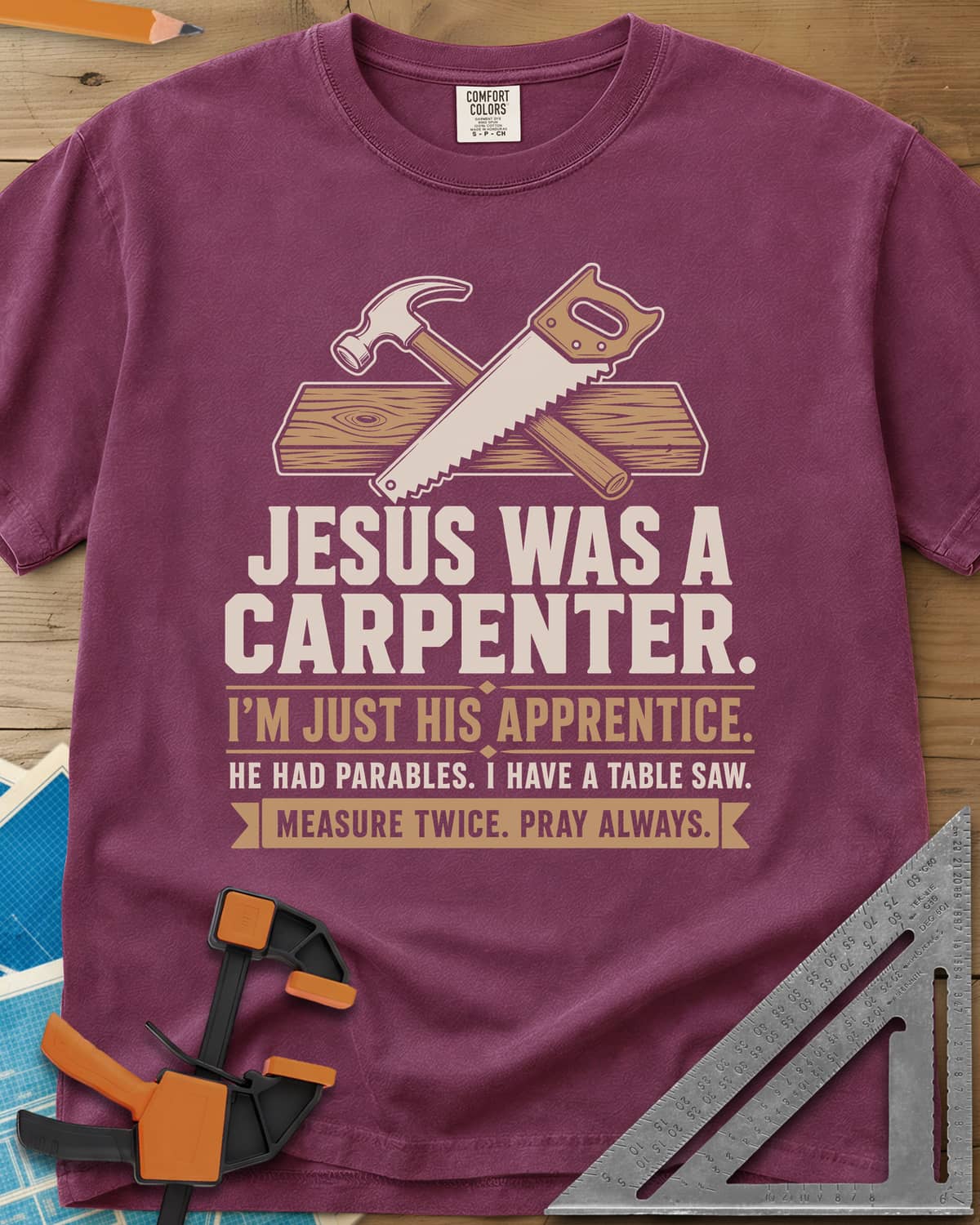 Jesus Was A Carpenter Apprentice heavyweight tee in Berry, crossed hammer and hand saw over a plank, with stacked lettering