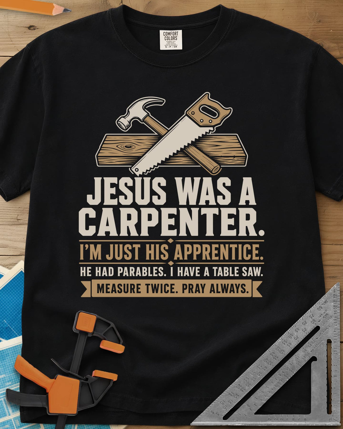 Jesus Was A Carpenter Apprentice heavyweight tee in Black, crossed hammer and hand saw over a plank, with stacked lettering