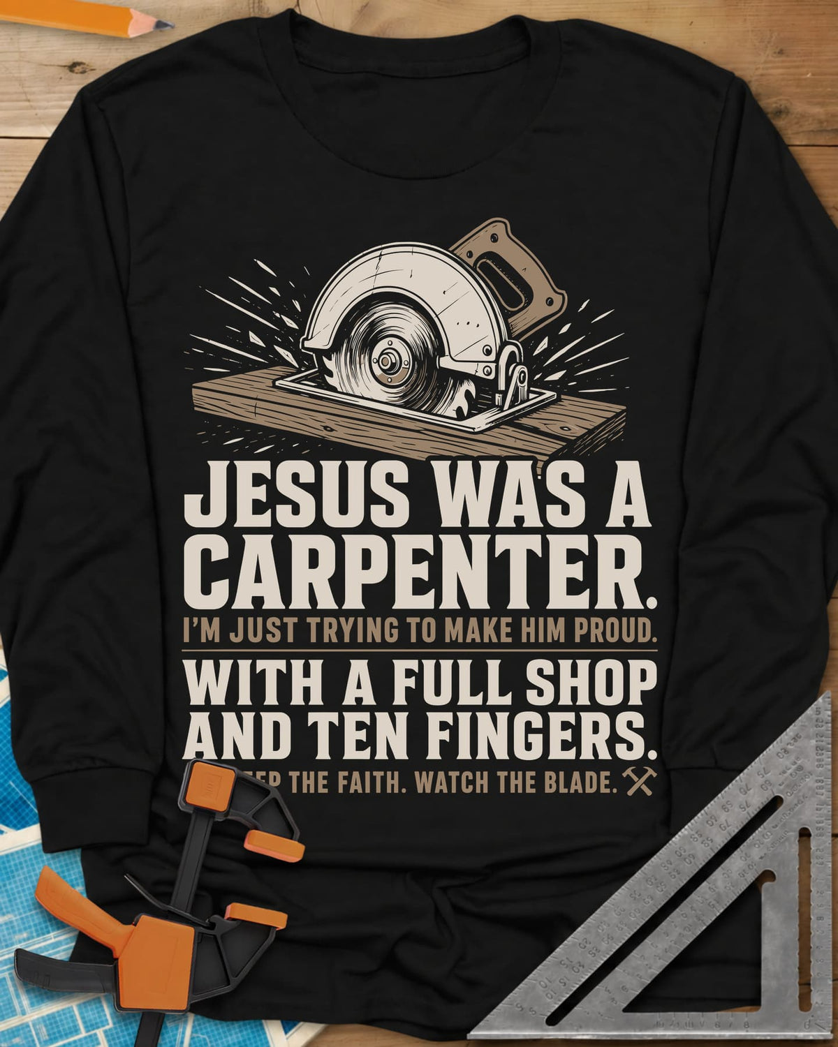 Jesus Was A Carpenter Proud long sleeve shirt in Black, a circular saw cutting a board with sparks flying