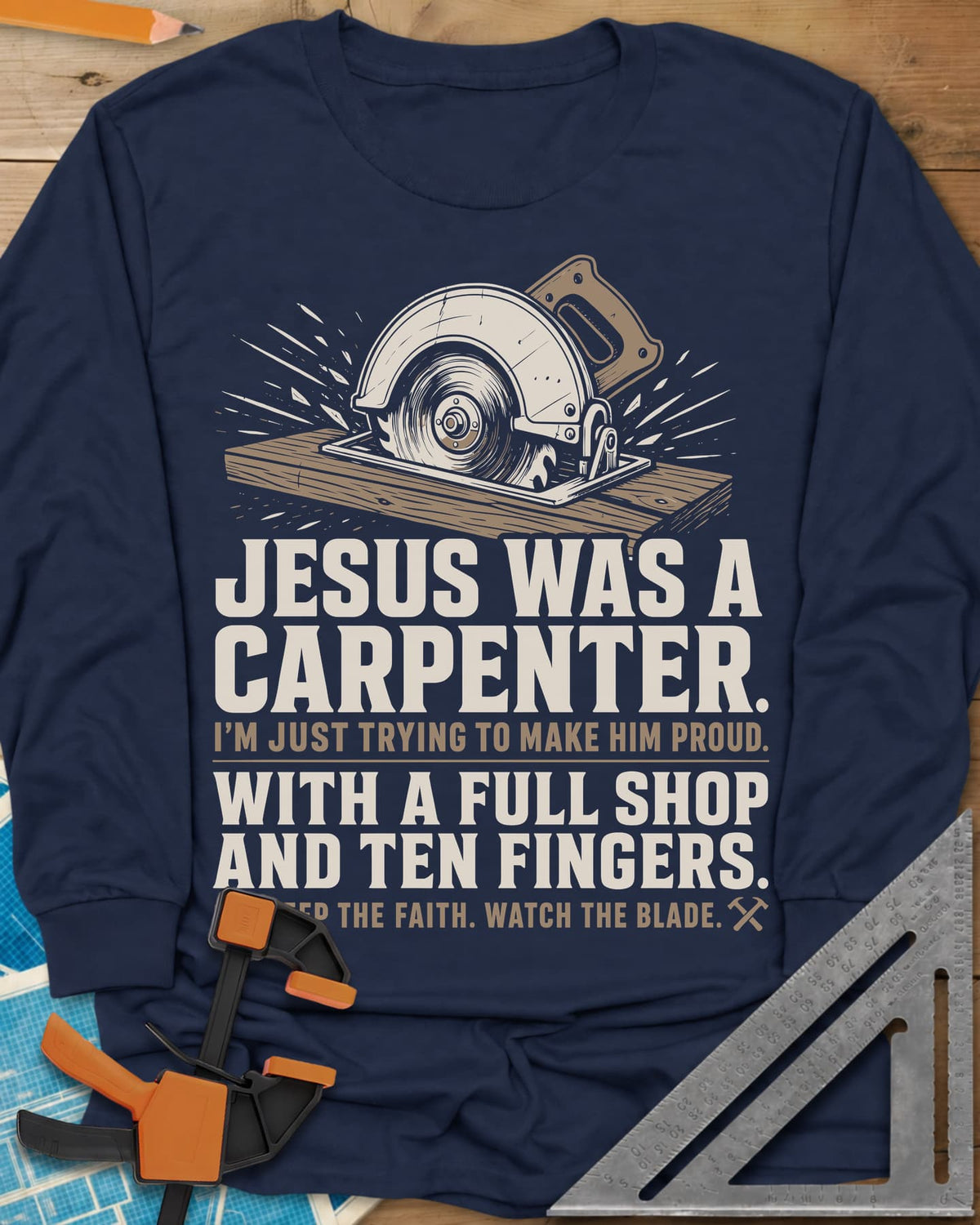 Jesus Was A Carpenter Proud long sleeve shirt in Navy, a circular saw cutting a board with sparks flying