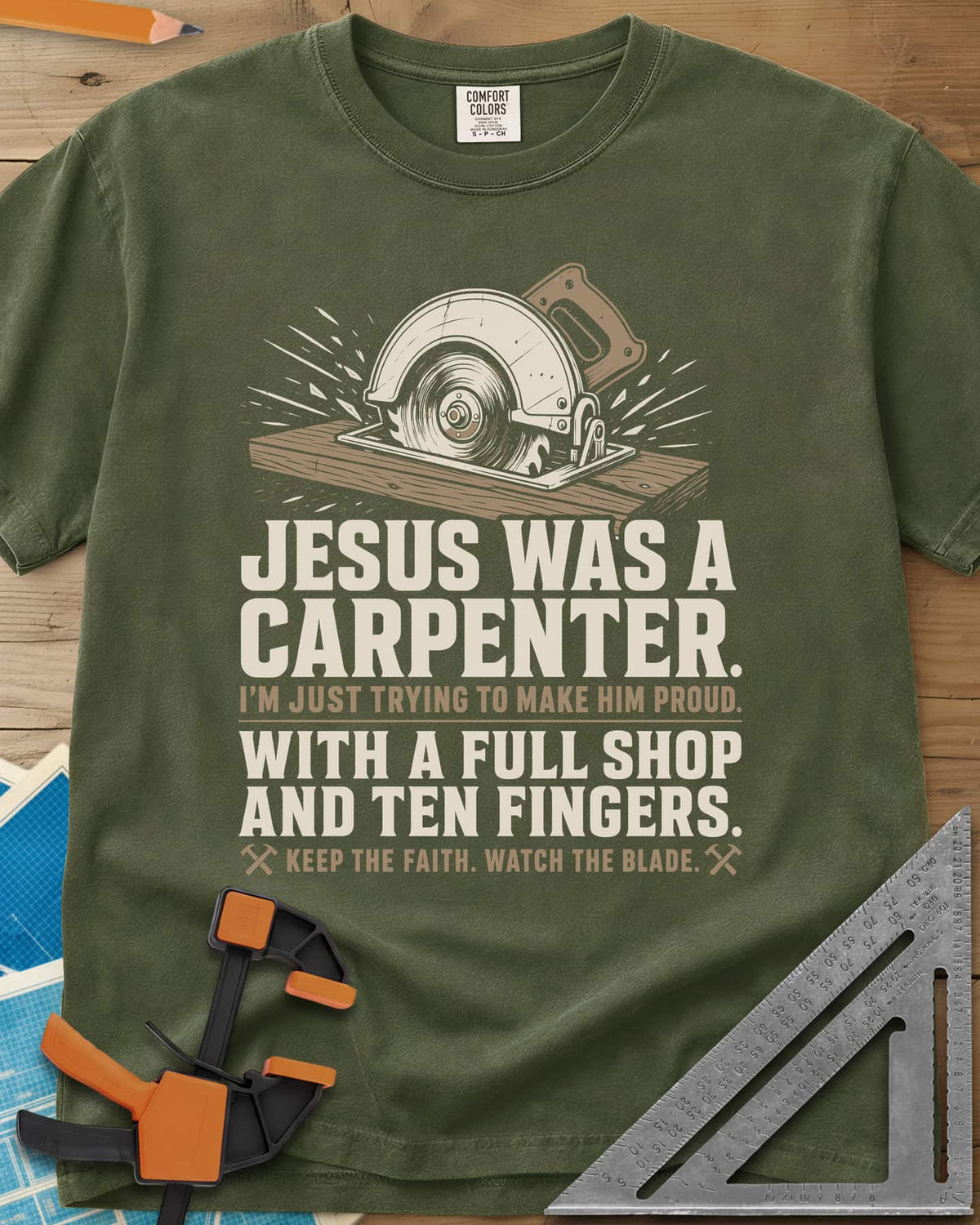 Jesus Was A Carpenter Proud heavyweight tee in Hemp, a circular saw cutting a board with sparks flying