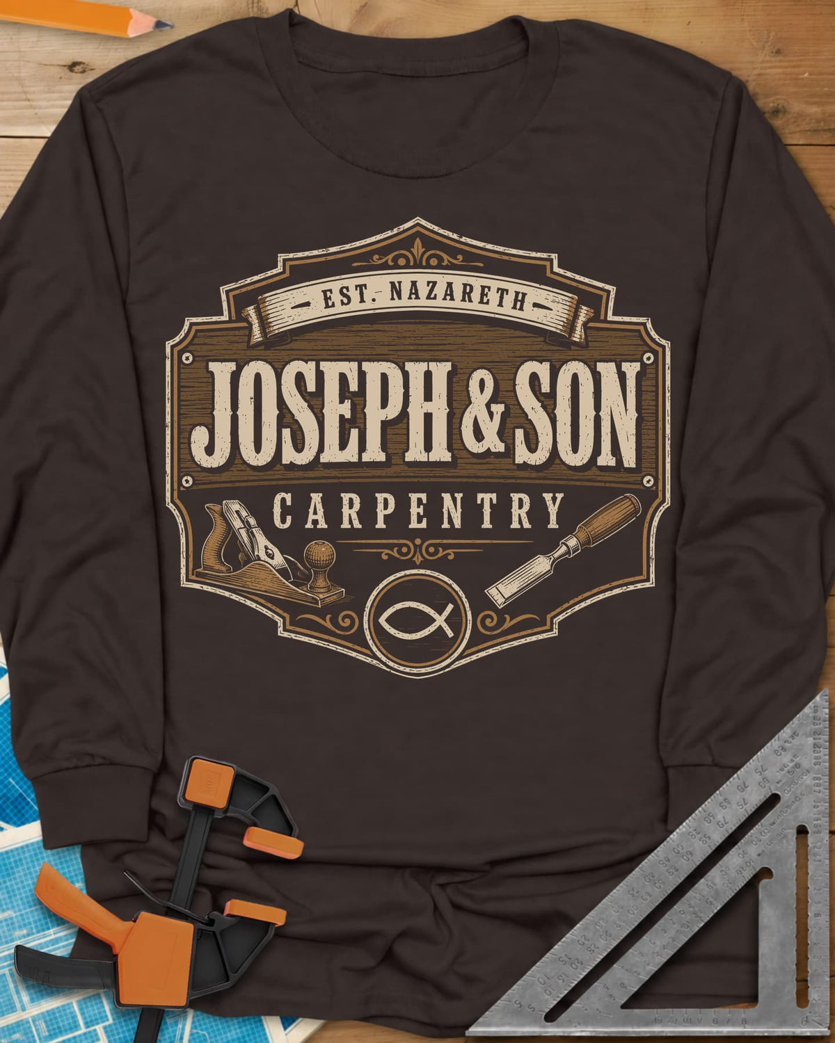 Joseph & Son Carpentry long sleeve shirt in Dark Chocolate, a shop-sign badge with a hand plane, chisel and fish symbol
