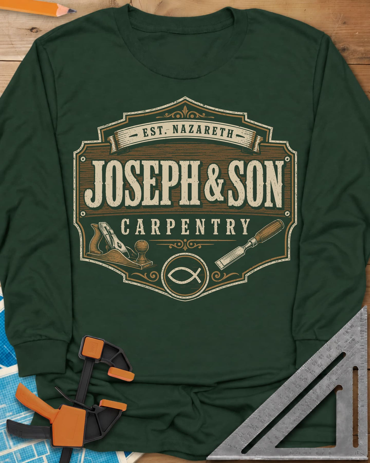 Joseph & Son Carpentry long sleeve shirt in Forest Green, a shop-sign badge with a hand plane, chisel and fish symbol