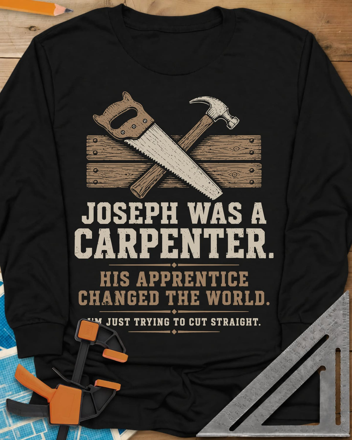 Joseph Was A Carpenter long sleeve shirt in Black, a crossed hand saw and hammer over two weathered boards