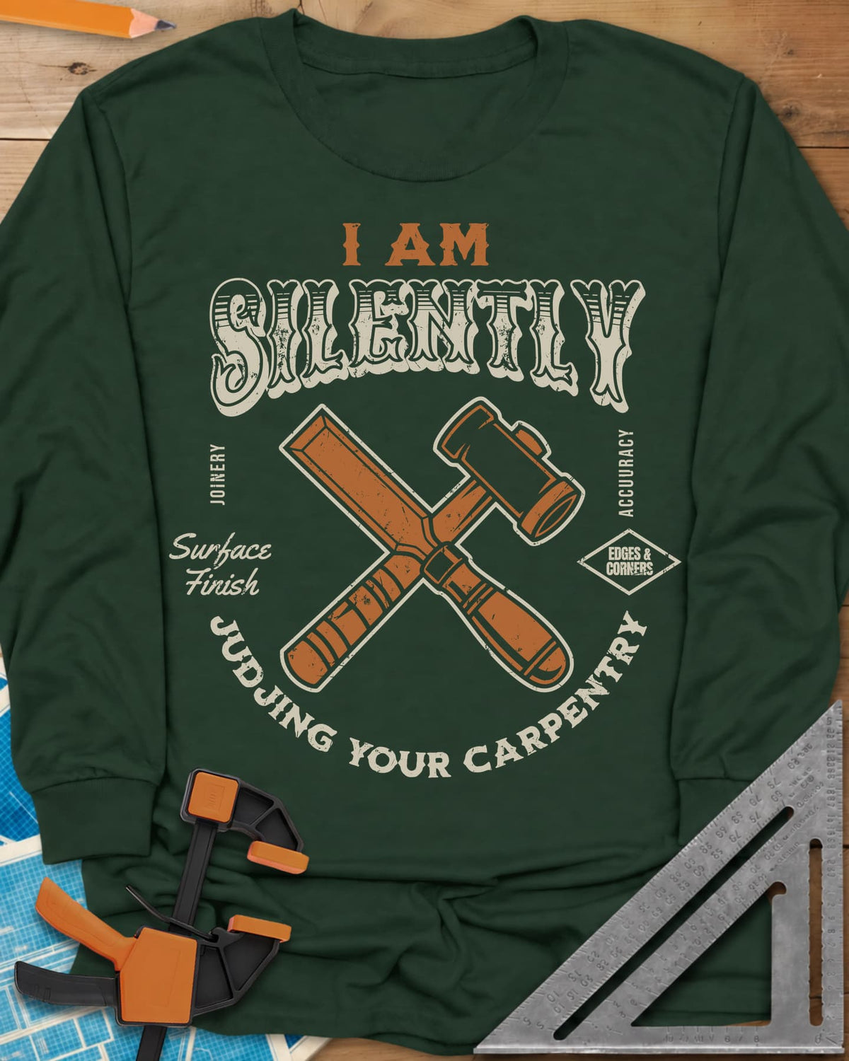 Judjing Your Carpentry long sleeve shirt in Forest Green, a crossed chisel and mallet in a badge with small shop labels