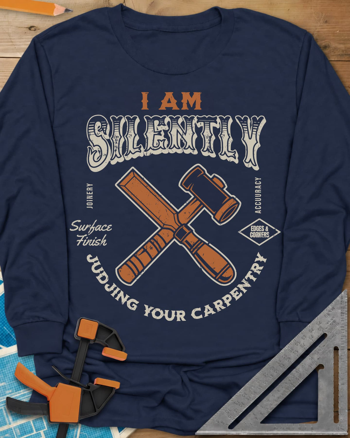 Judjing Your Carpentry long sleeve shirt in Navy, a crossed chisel and mallet in a badge with small shop labels