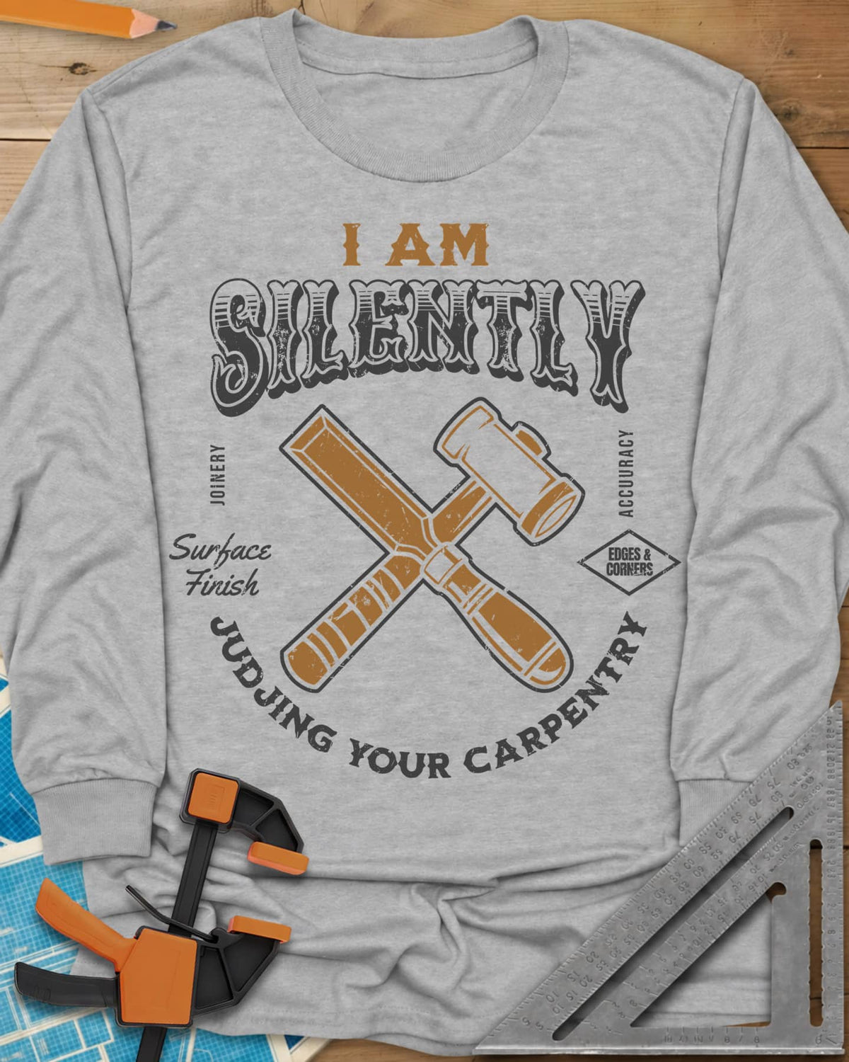 Judjing Your Carpentry long sleeve shirt in Sport Grey, a crossed chisel and mallet in a badge with small shop labels