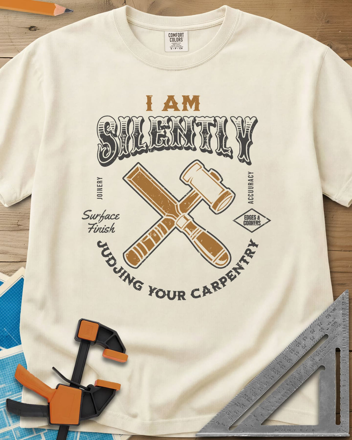 Judjing Your Carpentry heavyweight tee in Ivory, a crossed chisel and mallet in a badge with small shop labels