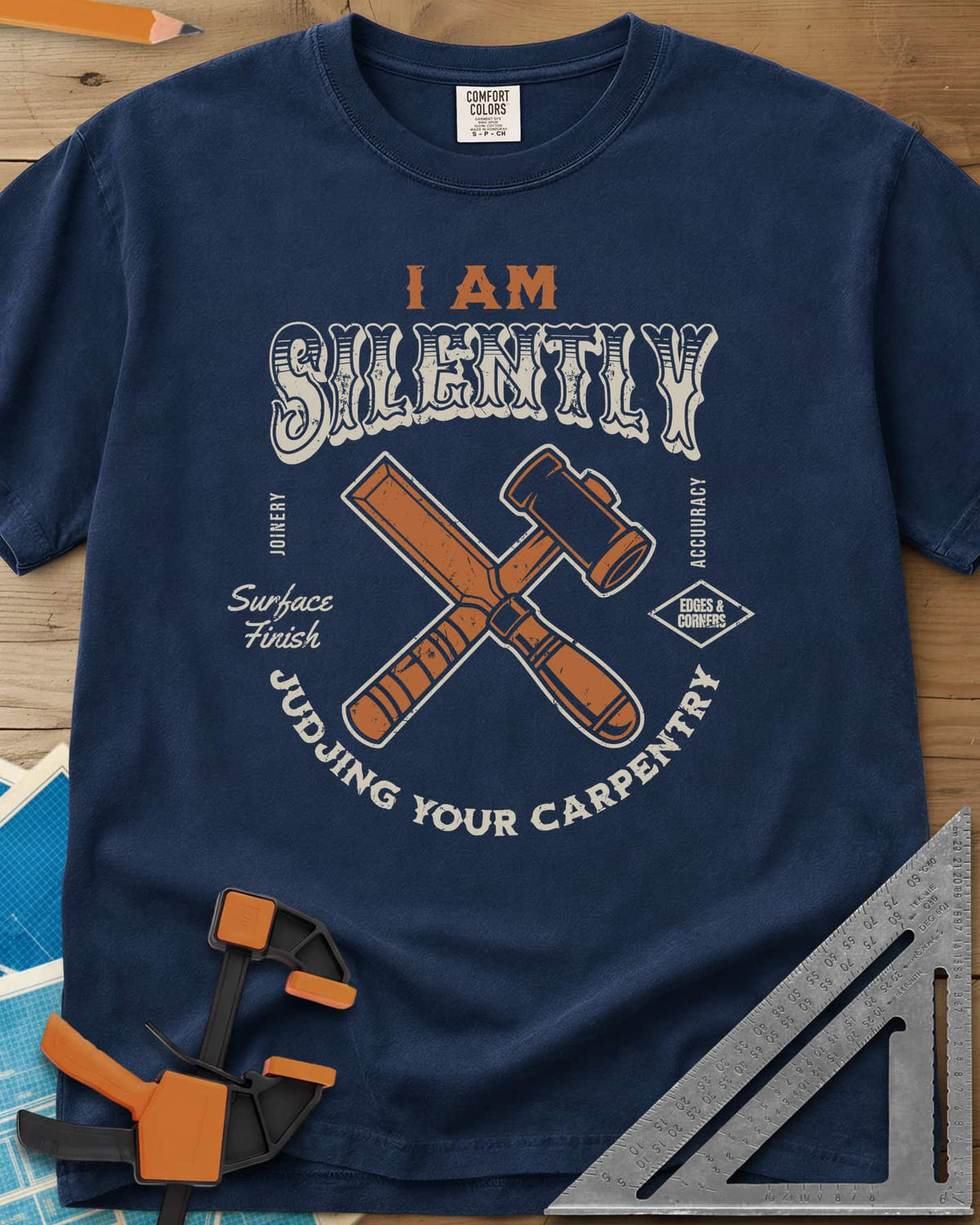 Judjing Your Carpentry heavyweight tee in Navy, a crossed chisel and mallet in a badge with small shop labels