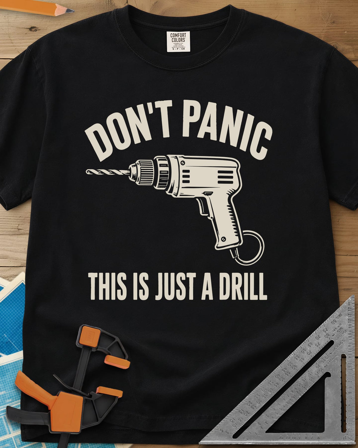 Just A Drill heavyweight tee in Black, a corded power drill between DON’T PANIC and the punchline