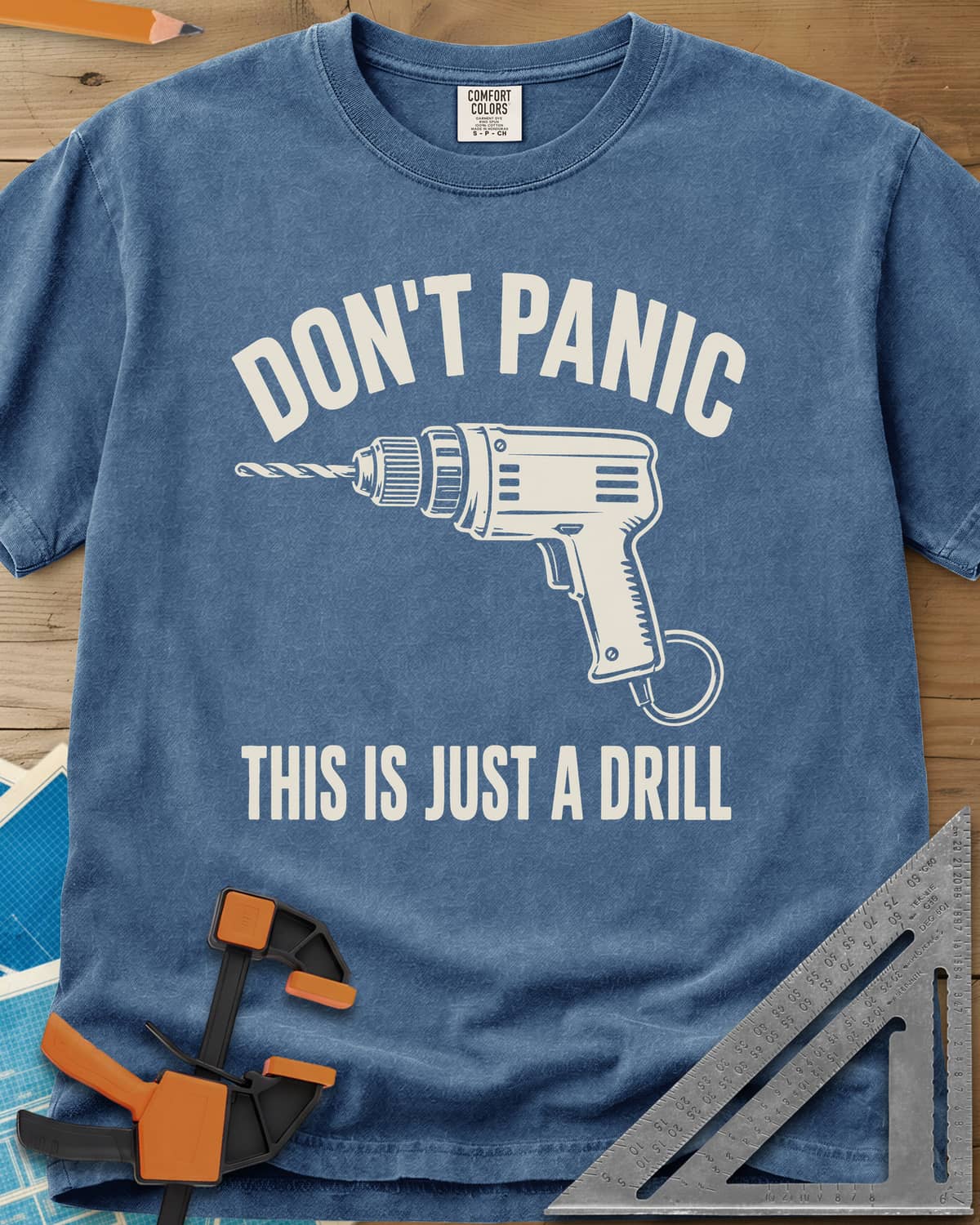 Just A Drill heavyweight tee in Blue Jean, a corded power drill between DON’T PANIC and the punchline