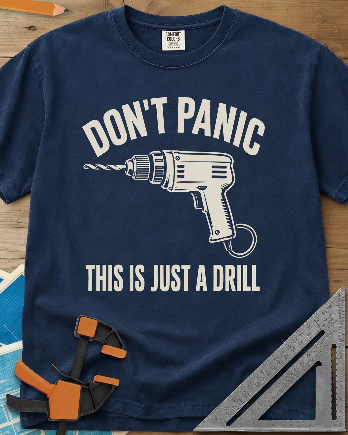 Just A Drill heavyweight tee in Navy, a corded power drill between DON’T PANIC and the punchline