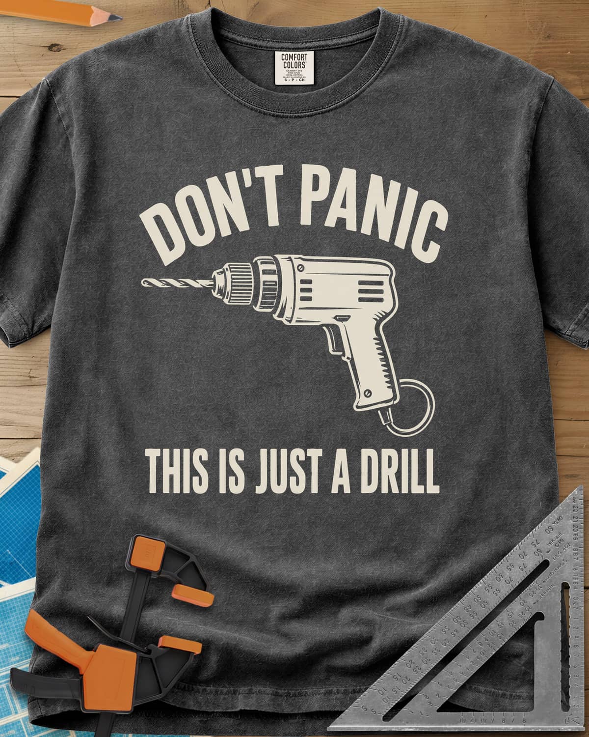 Just A Drill heavyweight tee in Pepper, a corded power drill between DON’T PANIC and the punchline