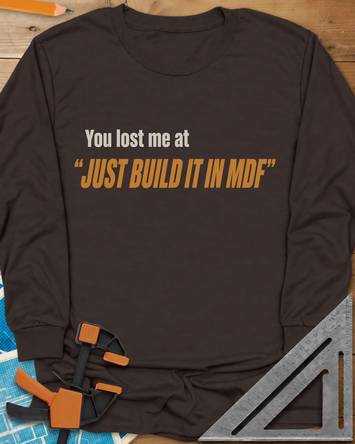Just Build It In MDF long sleeve shirt in Dark Chocolate, small plain text over bold italic lettering, no graphic
