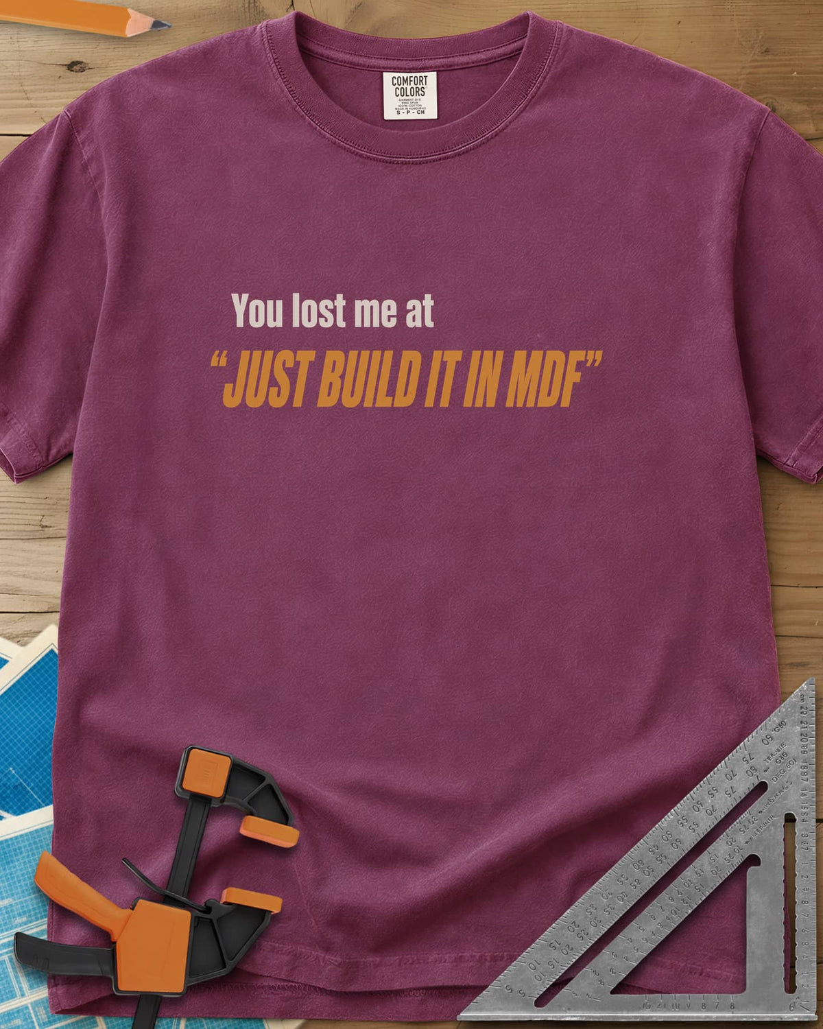 Just Build It In MDF heavyweight tee in Berry, small plain text over bold italic lettering, no graphic