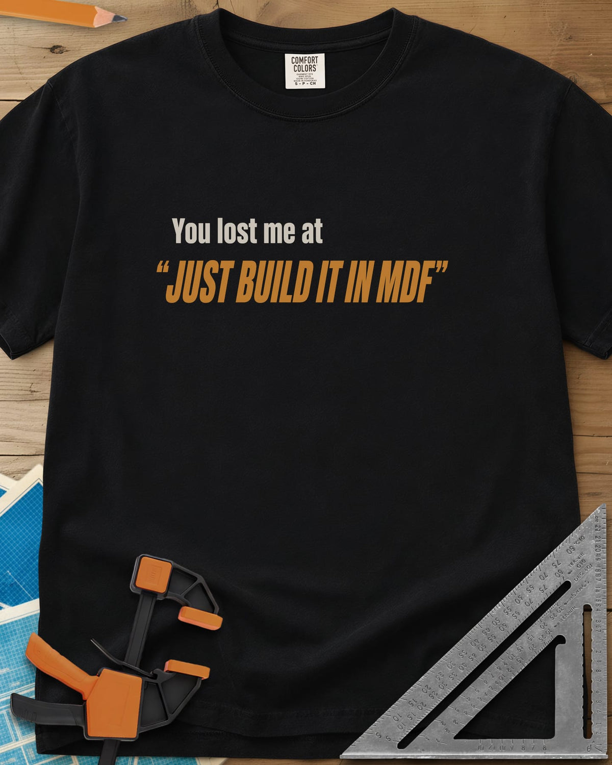 Just Build It In MDF heavyweight tee in Black, small plain text over bold italic lettering, no graphic