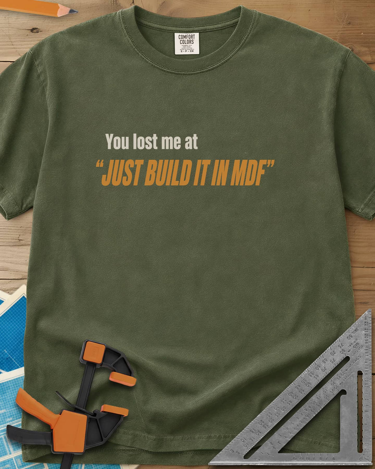 Just Build It In MDF heavyweight tee in Hemp, small plain text over bold italic lettering, no graphic