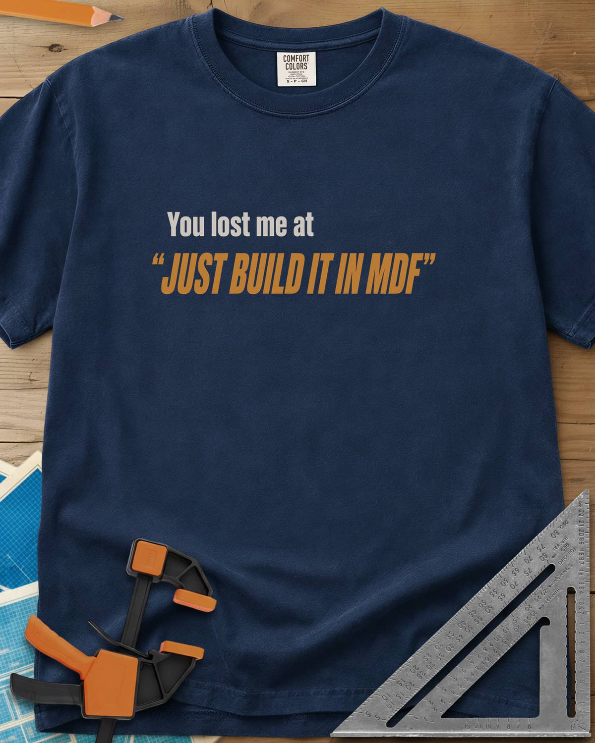 Just Build It In MDF heavyweight tee in Navy, small plain text over bold italic lettering, no graphic