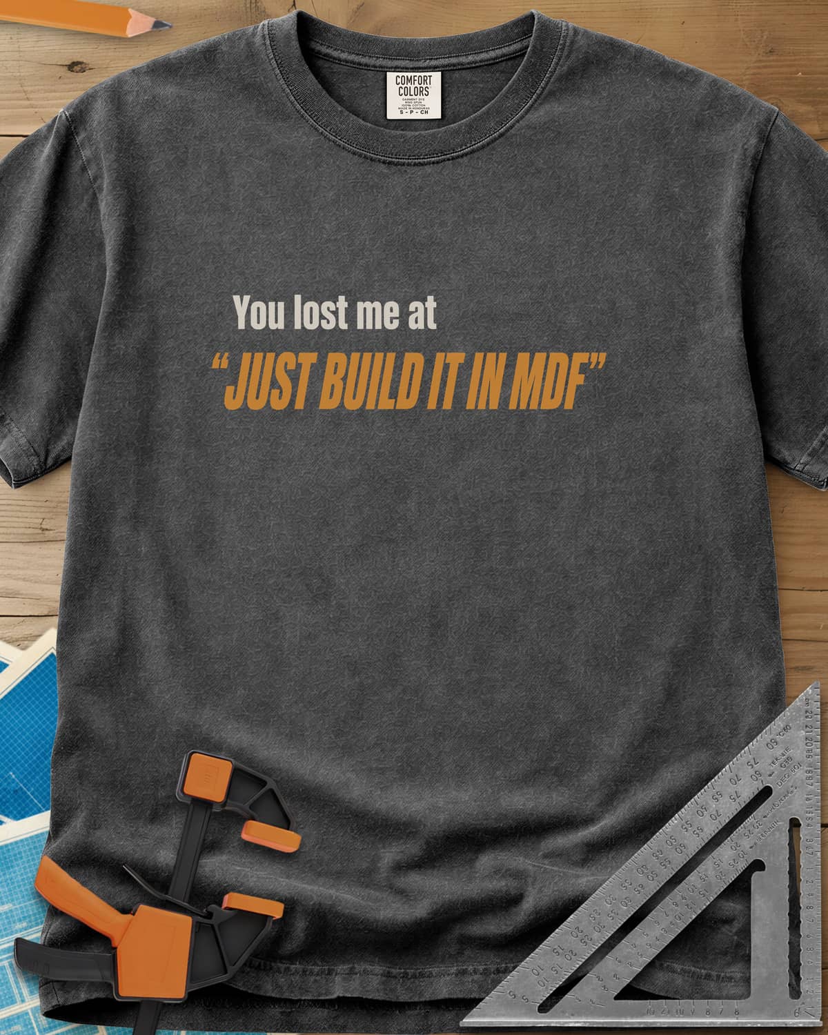 Just Build It In MDF heavyweight tee in Pepper, small plain text over bold italic lettering, no graphic
