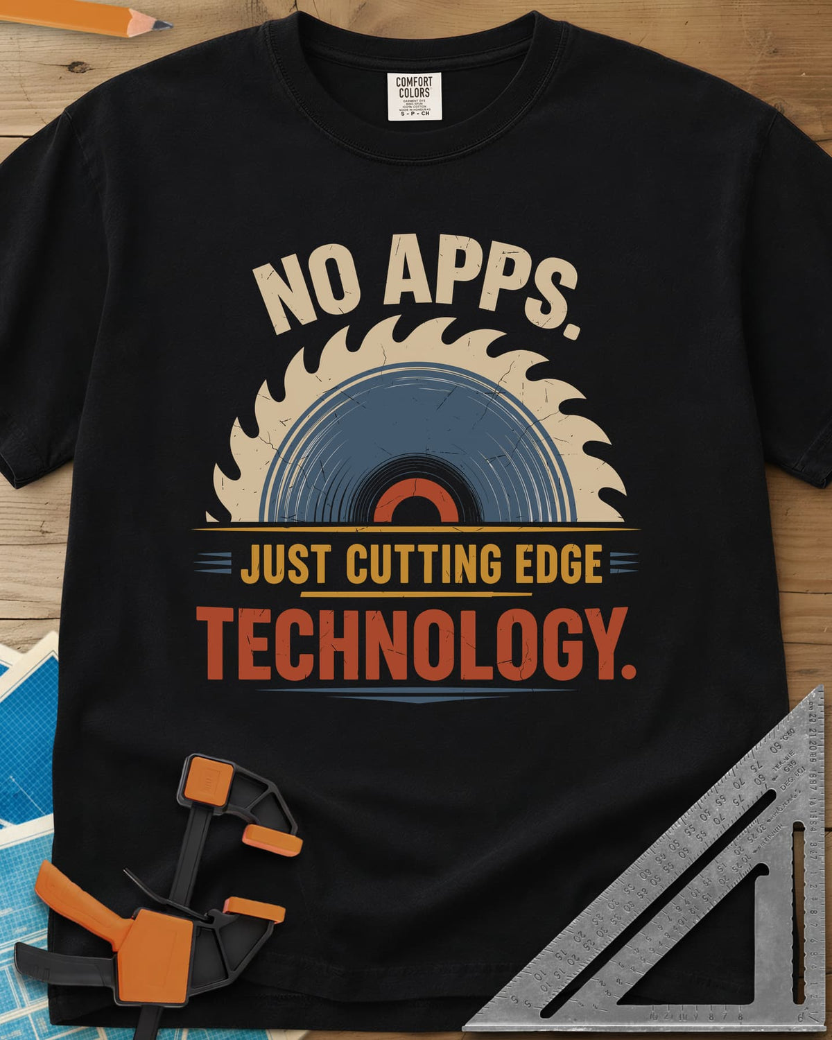 Just Cutting Edge Technology heavyweight tee in Black, half a saw blade rising like a sun in cream, blue and rust