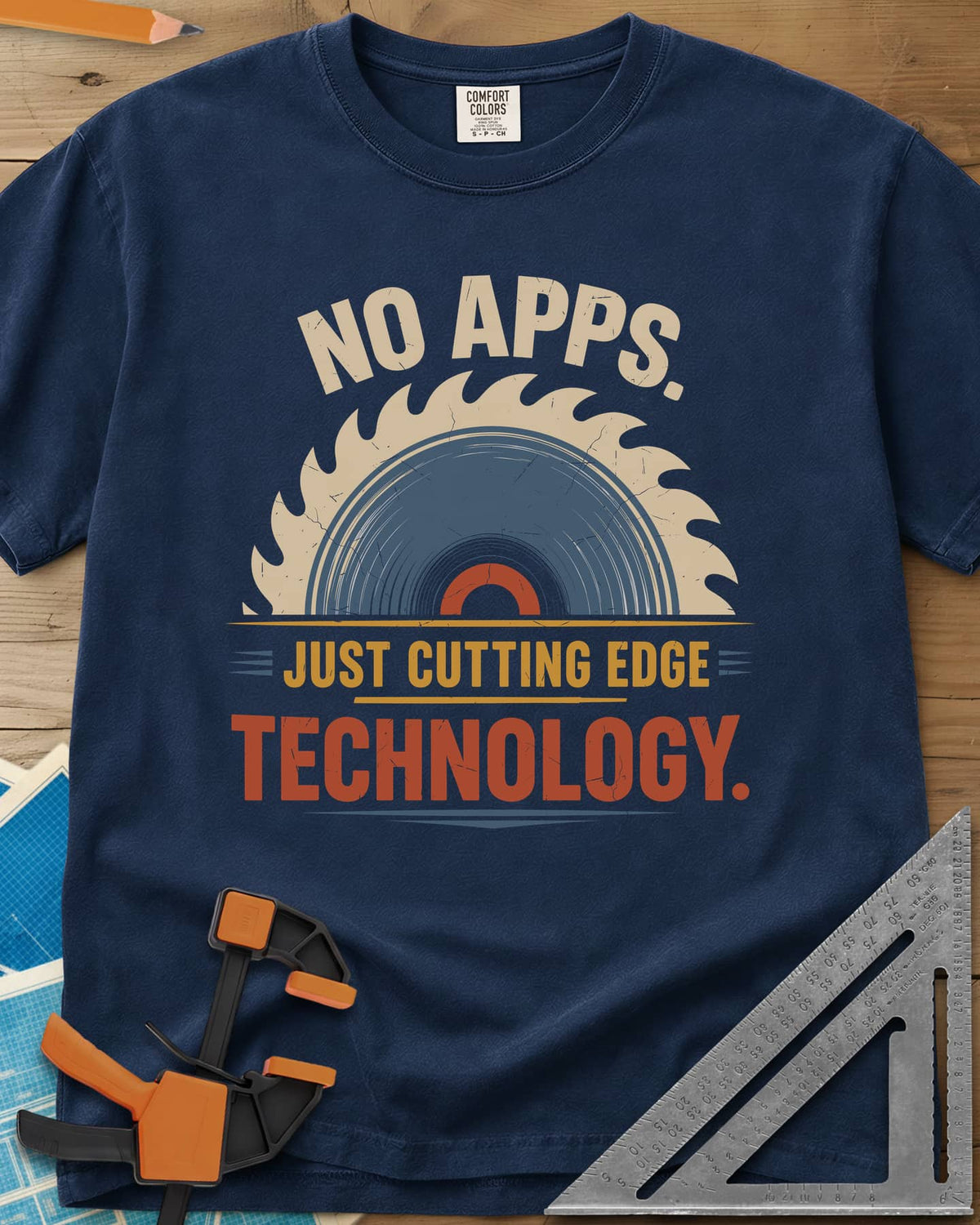 Just Cutting Edge Technology heavyweight tee in Navy, half a saw blade rising like a sun in cream, blue and rust
