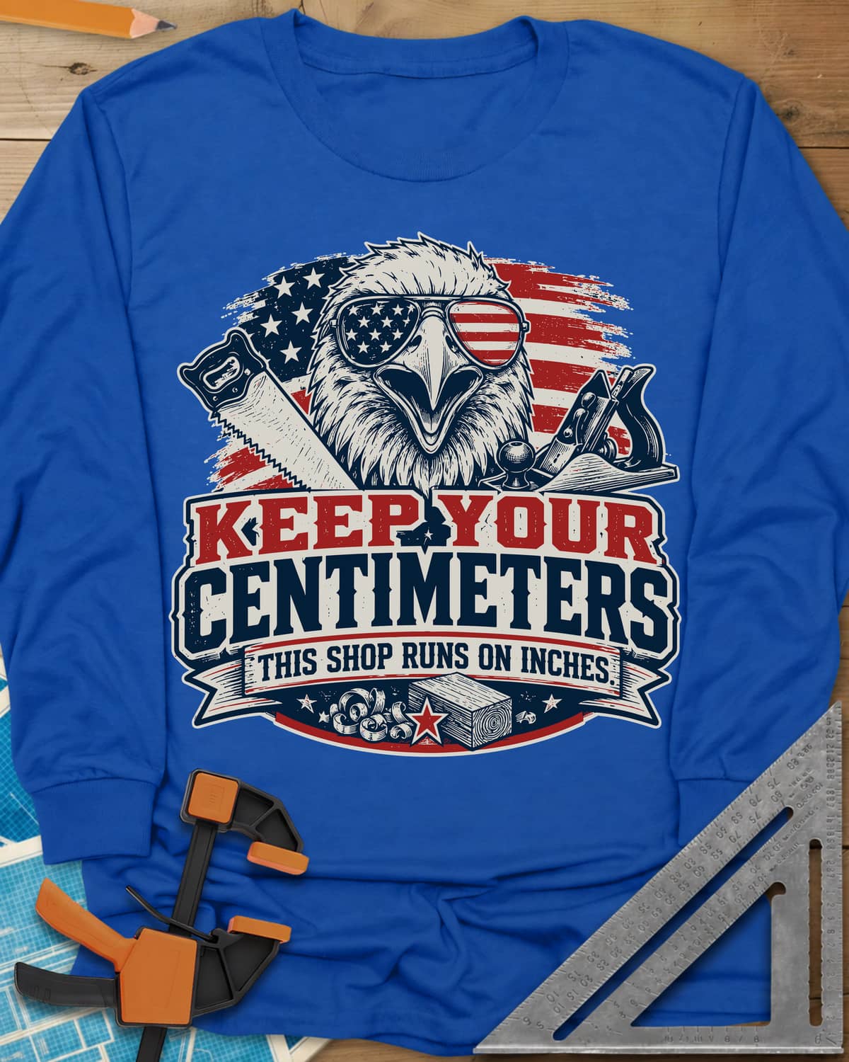Keep Your Centimeters long sleeve shirt in Royal, an eagle in flag sunglasses with a handsaw, plane and banner