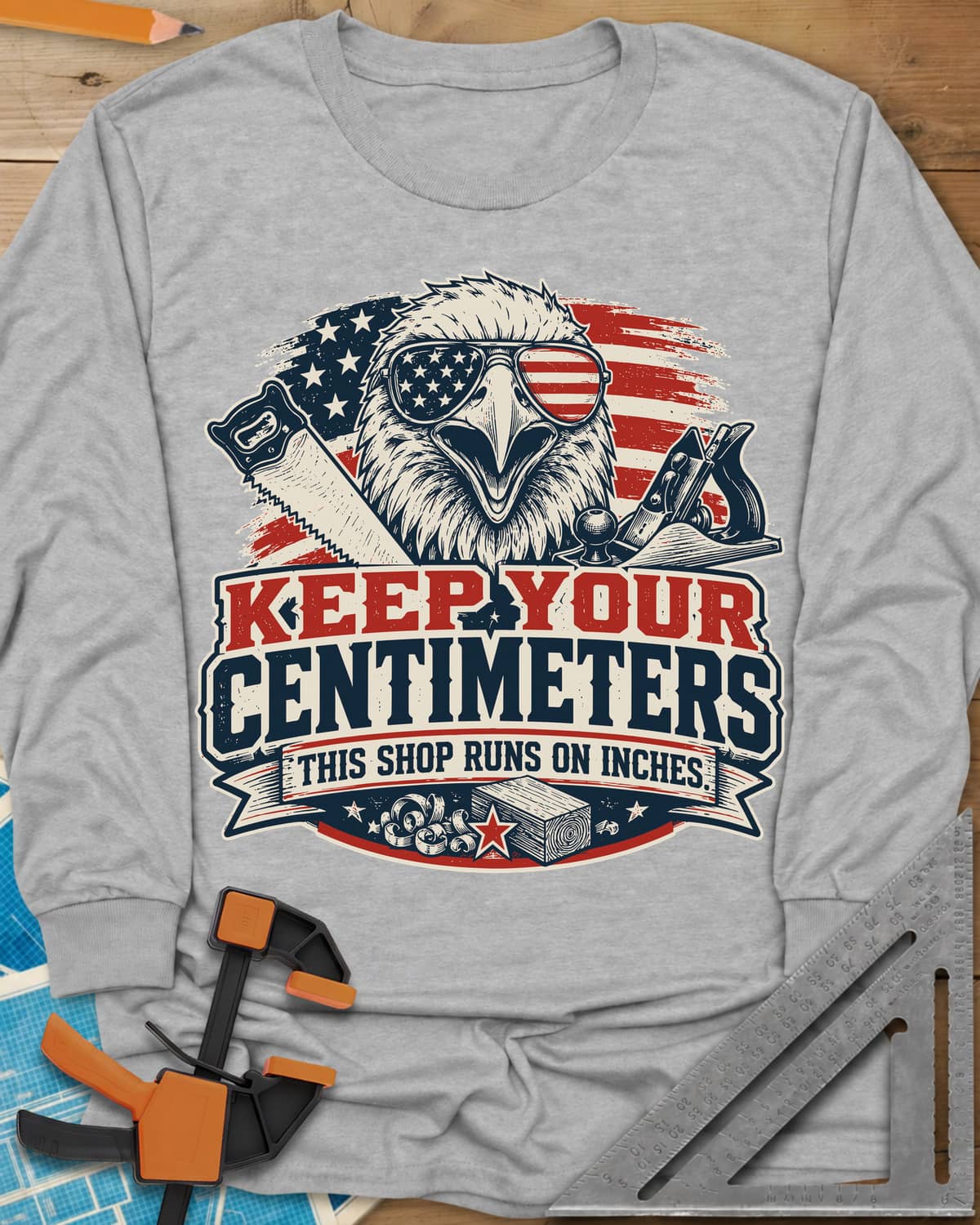 Keep Your Centimeters long sleeve shirt in Sport Grey, an eagle in flag sunglasses with a handsaw, plane and banner