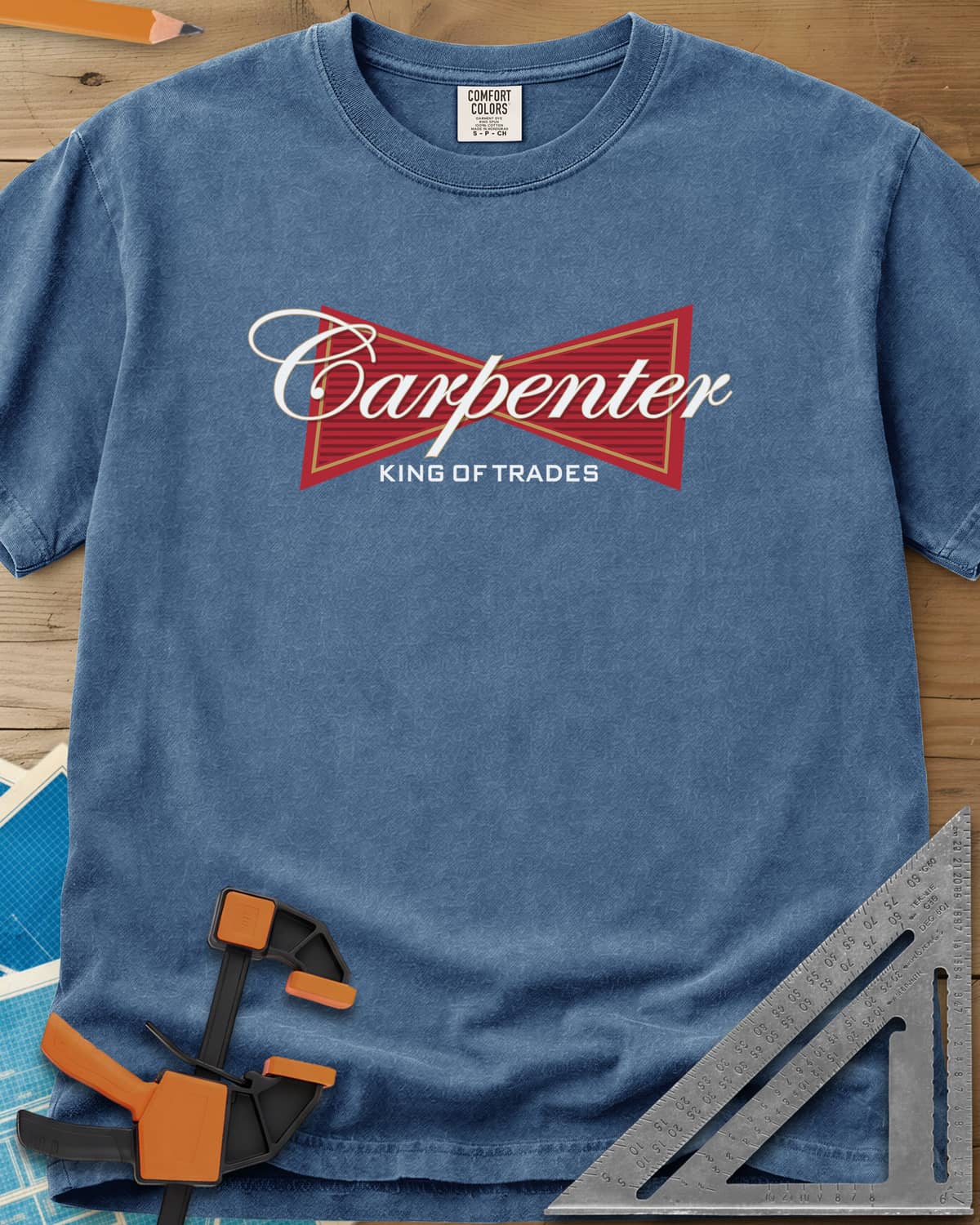 King of Trades heavyweight tee in Blue Jean, a red bow-tie badge with white script and gold trim