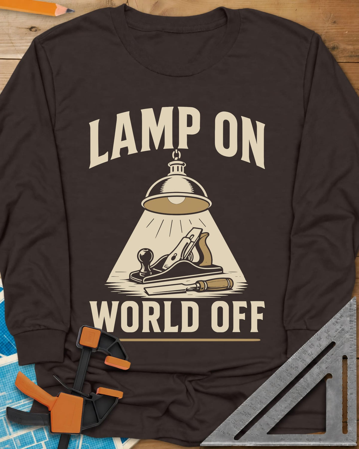 Lamp On World Off long sleeve shirt in Dark Chocolate, a pendant shop lamp lighting a hand plane and chisel