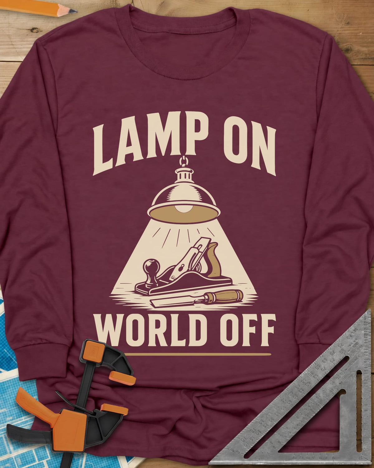 Lamp On World Off long sleeve shirt in Maroon, a pendant shop lamp lighting a hand plane and chisel