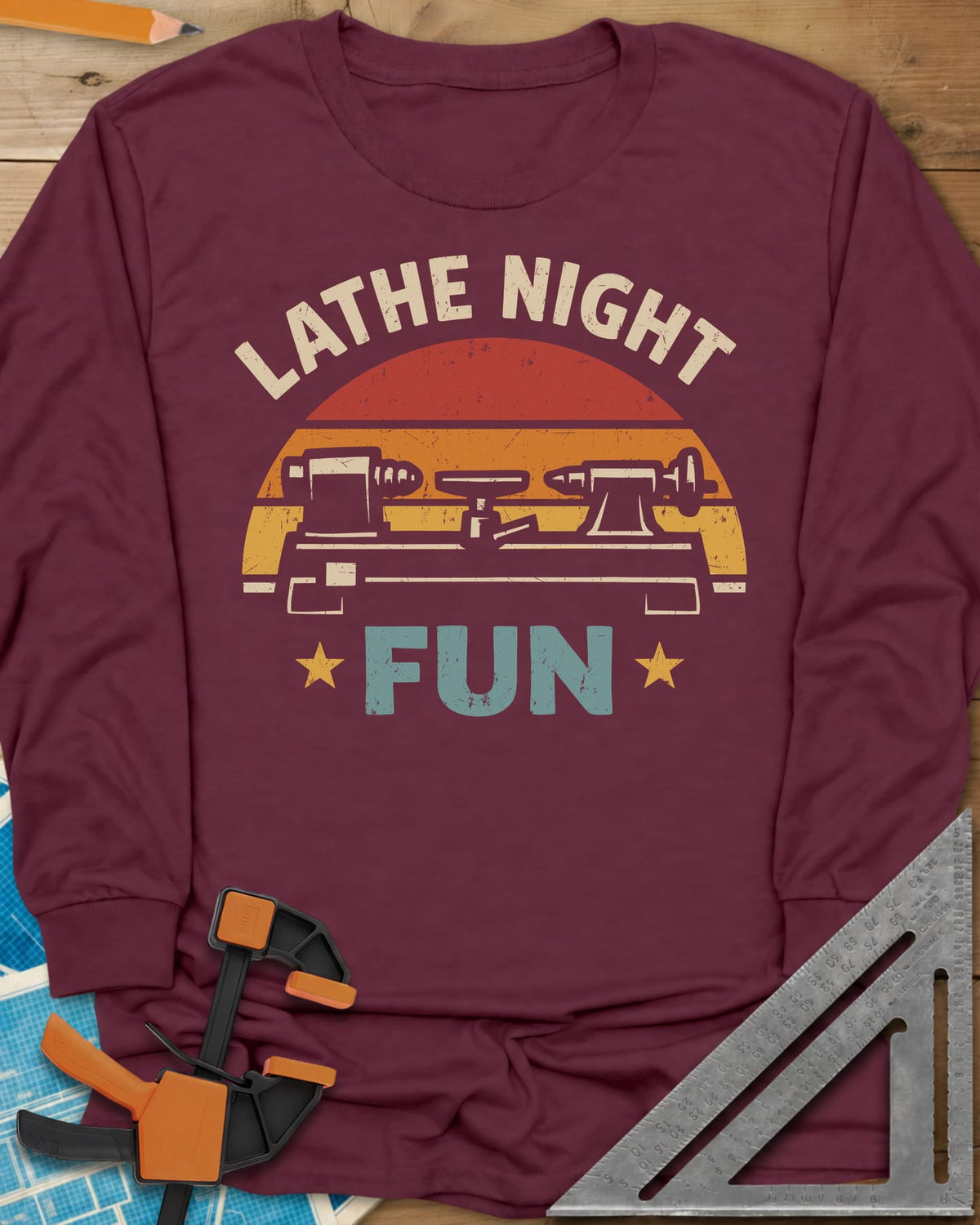 Lathe Night Fun long sleeve shirt in Maroon, a retro striped sunset behind a wood lathe with stars
