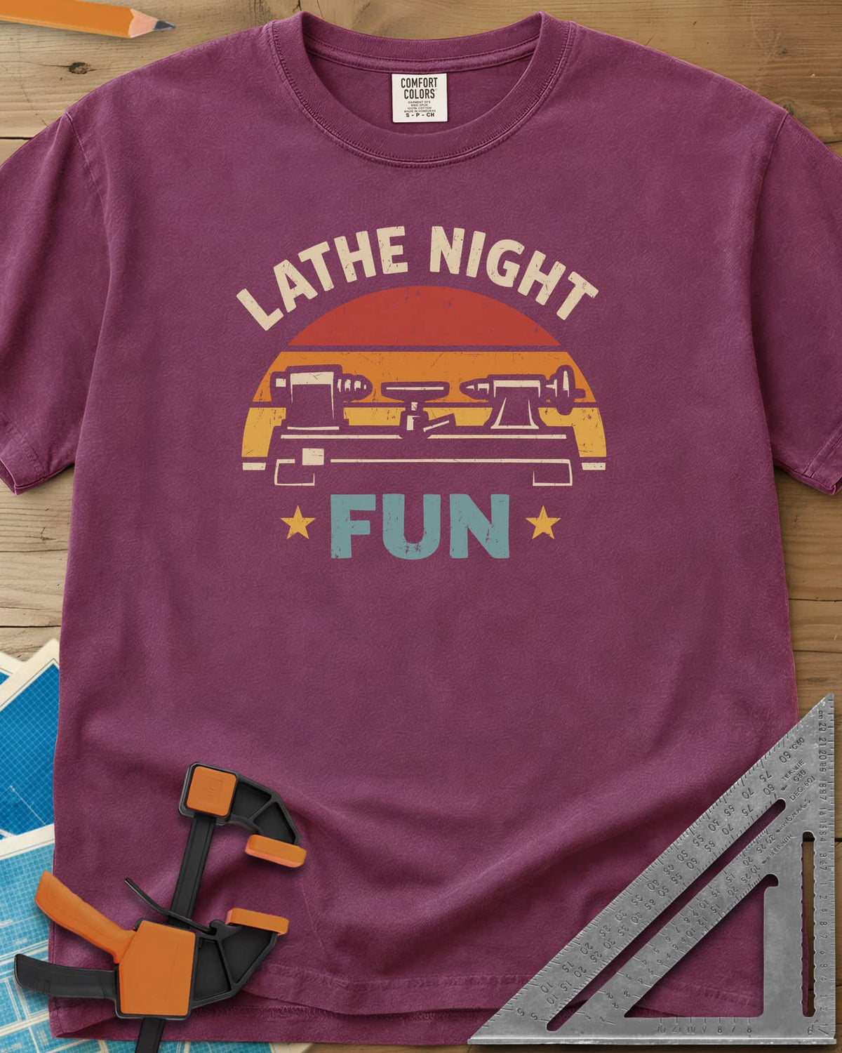 Lathe Night Fun heavyweight tee in Berry, a retro striped sunset behind a wood lathe with stars
